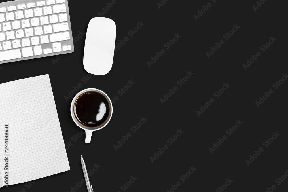 Black office desk table with computer gadgets and supplies. Top view with copy space, flat lay.