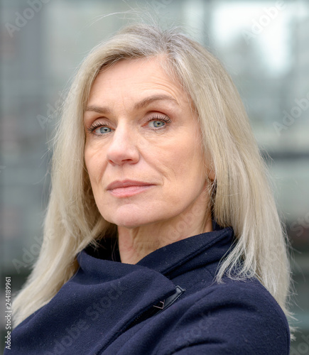 Middle-aged woman looking thoughtfully at camera