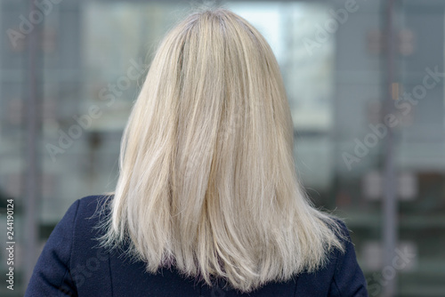 Rear of a woman with shoulder length blond hair