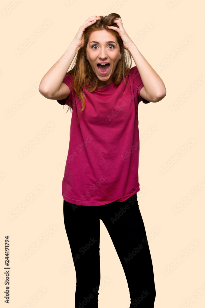 Young redhead girl with surprise and shocked facial expression on isolated yellow background Young redhead girl with surprise and shocked facial expression on isolated yellow background