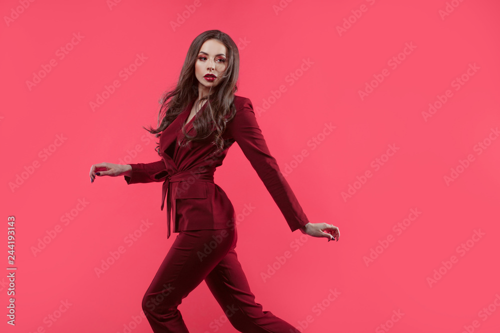 Stylish glamorous girl. Attractive young brunette dressed in fuchsia color, fuchsia color background Stylish glamorous girl. Attractive young brunette dressed in fuchsia color, fuchsia color background
