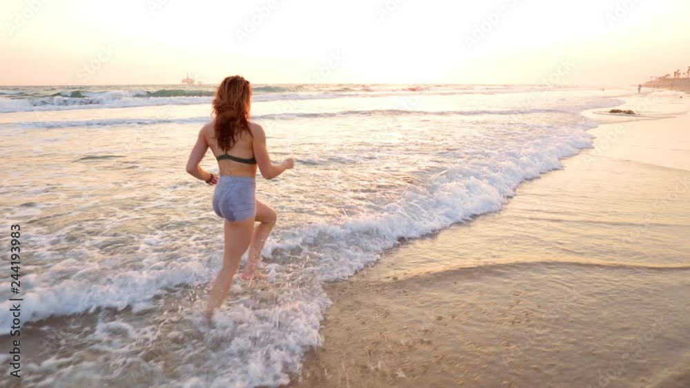 Very fit woman working out on the beach at sunset. Very fit woman working out on the beach at sunset.