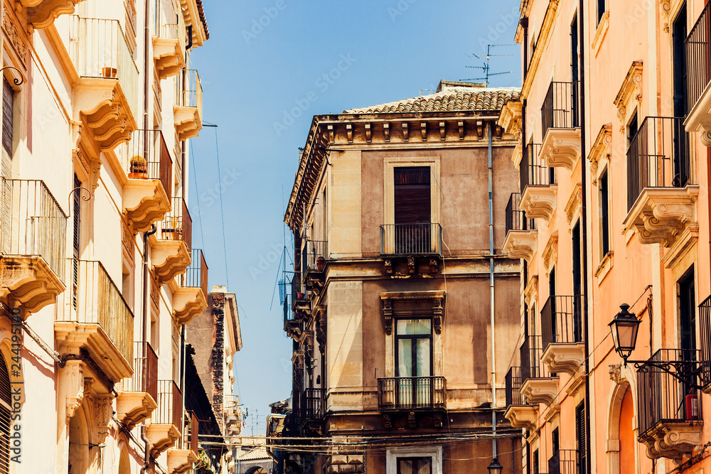 Italian background. Historical street of Catania, Sicily, facade of old building.