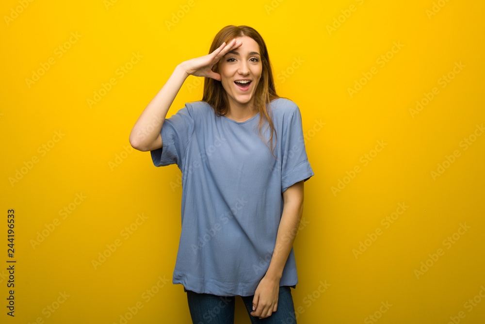 Young redhead girl over yellow wall background has just realized something and has intending the solution Young redhead girl over yellow wall background has just realized something and has intending the solution
