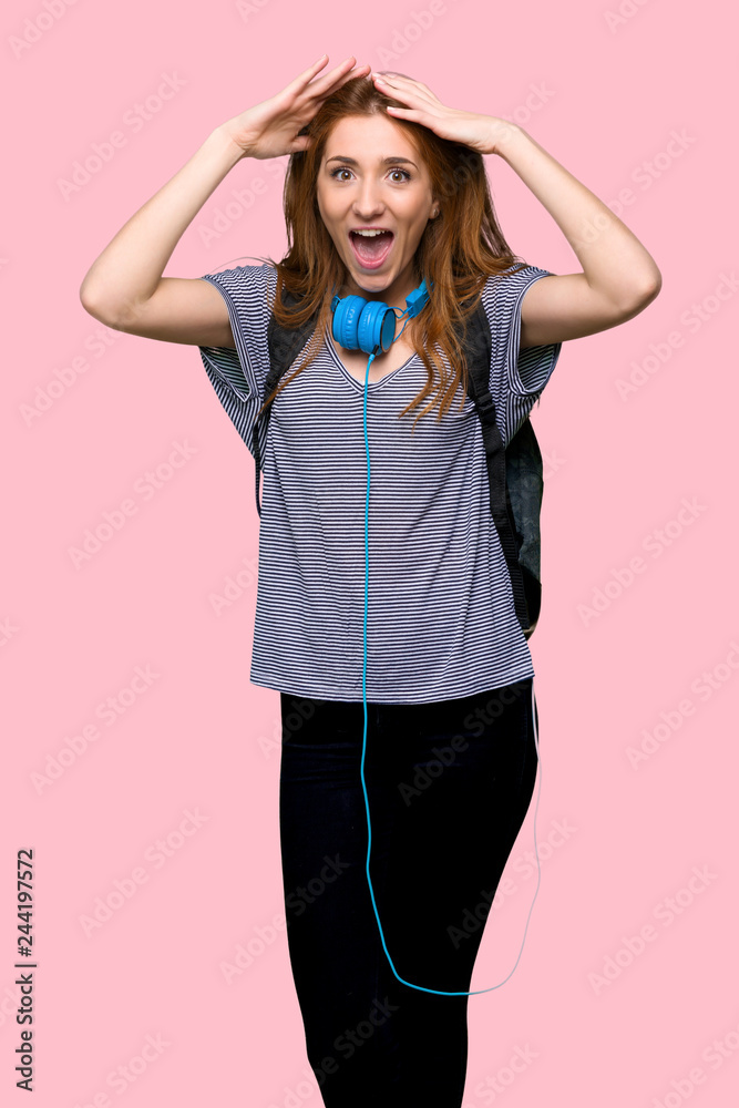 Redhead student woman with surprise and shocked facial expression on isolated pink background Redhead student woman with surprise and shocked facial expression on isolated pink background