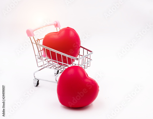 The small red heart put in shopping cart and the one put on background,blurry light around