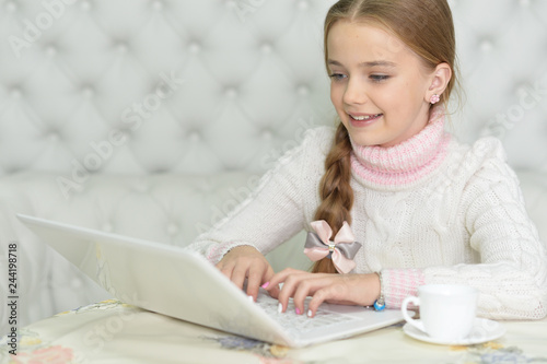 Portrait of cute beautiful girl using laptop