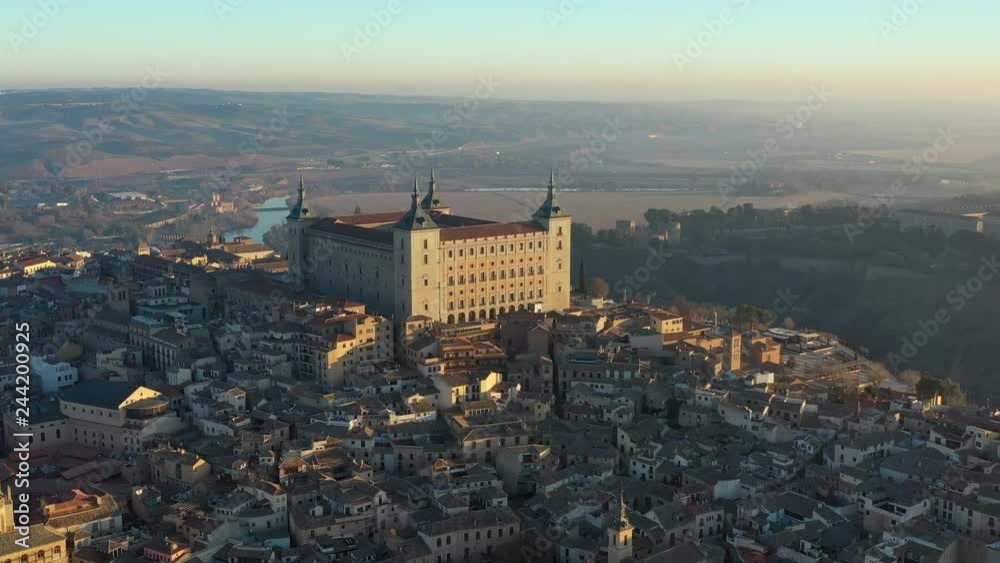 Aerial view of cityscape of Toledo at sunrise, historic center of city, castle Alcazar de Toledo - landscape panorama of Castilla–La Mancha from above, Spain, Europe