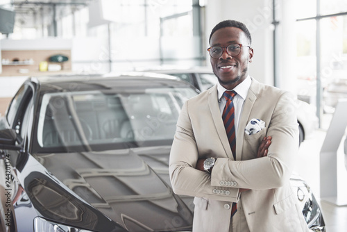The young attractive black businessman buys a new car, dreams come true