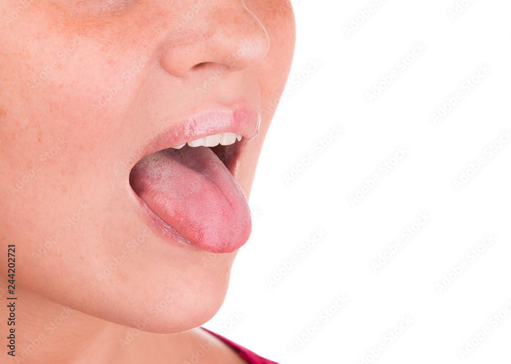 Obraz premium The girl shows tongue on a white background.