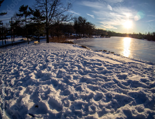 wide angle view of frozen lake in winter end of afternoon