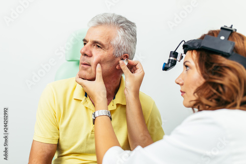 Senior man at medical examination or checkup in otolaryngologist's office