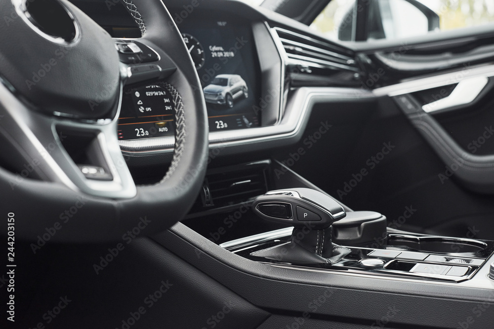 Interior of a prestigious modern black car. Leather comfortable seats and accessories and steering wheel