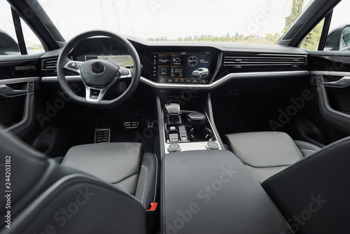 Interior of a prestigious modern black car. Leather comfortable seats and accessories and steering wheel
