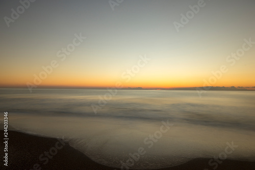 Sunrise on the beach in long exposure © vicenfoto