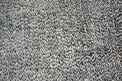 Detail of black and white stones on cement in Oia, Santorini