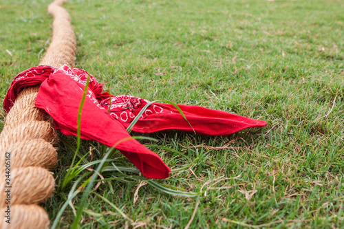 Rope With Bandana Lies On Grass Before Tug Of War