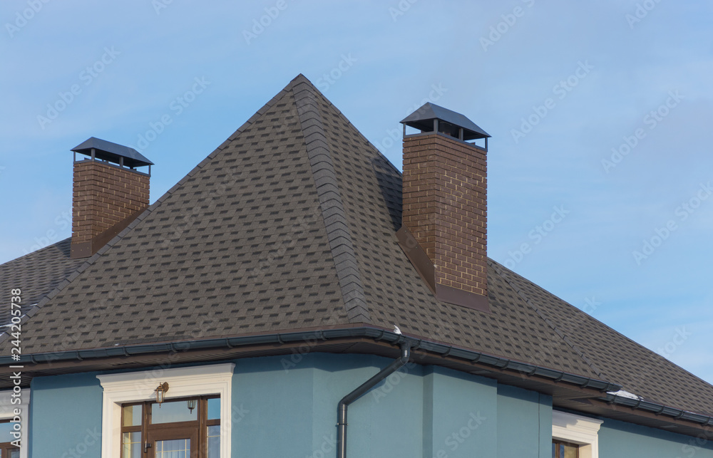 New tiled roof with brick chimney