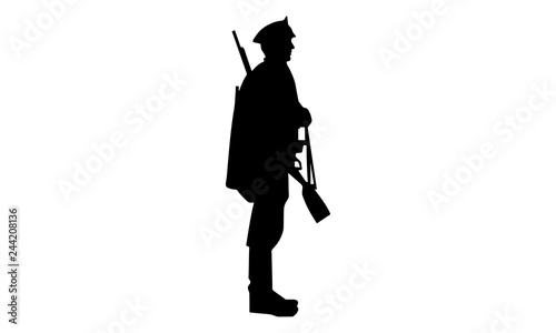 the soldier's silhouette stood upright with a long barrel gun looking sideways