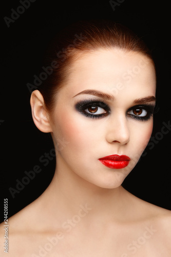 Portrait of young beautiful woman with fancy smoky eye make-up