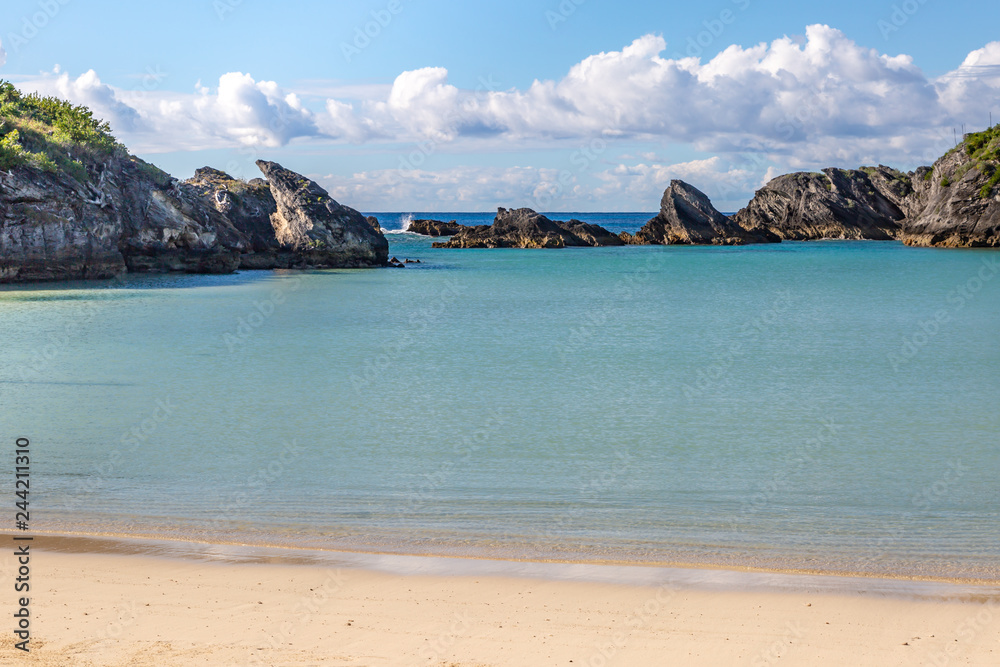 An idyllic Bermudan beach, with rock formations in the sea