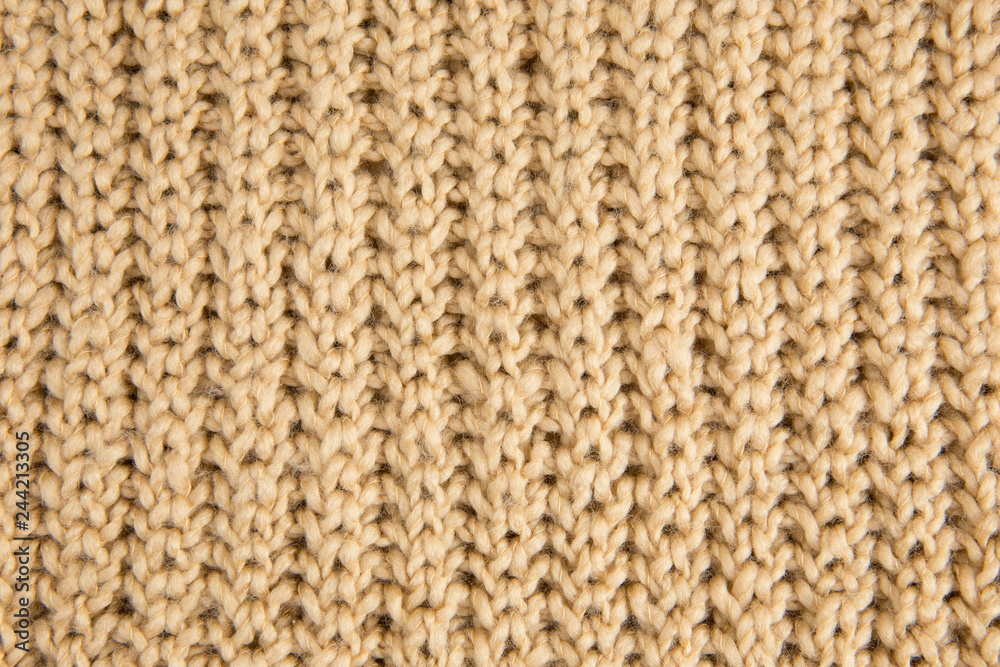 Brown knitted woolen fabric textile background. Vertical lines. Brown knitted woolen fabric textile background. Vertical lines.
