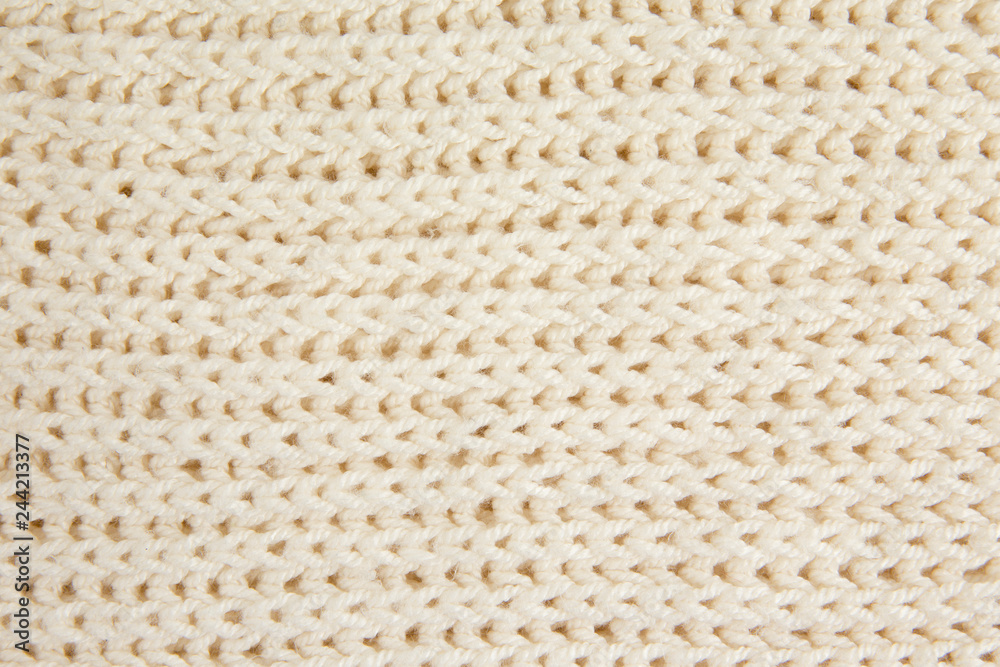 White knitted woolen fabric textile background. Horizontal lines. White knitted woolen fabric textile background. Horizontal lines.