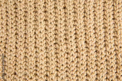 Brown knitted woolen fabric textile background. Vertical lines.