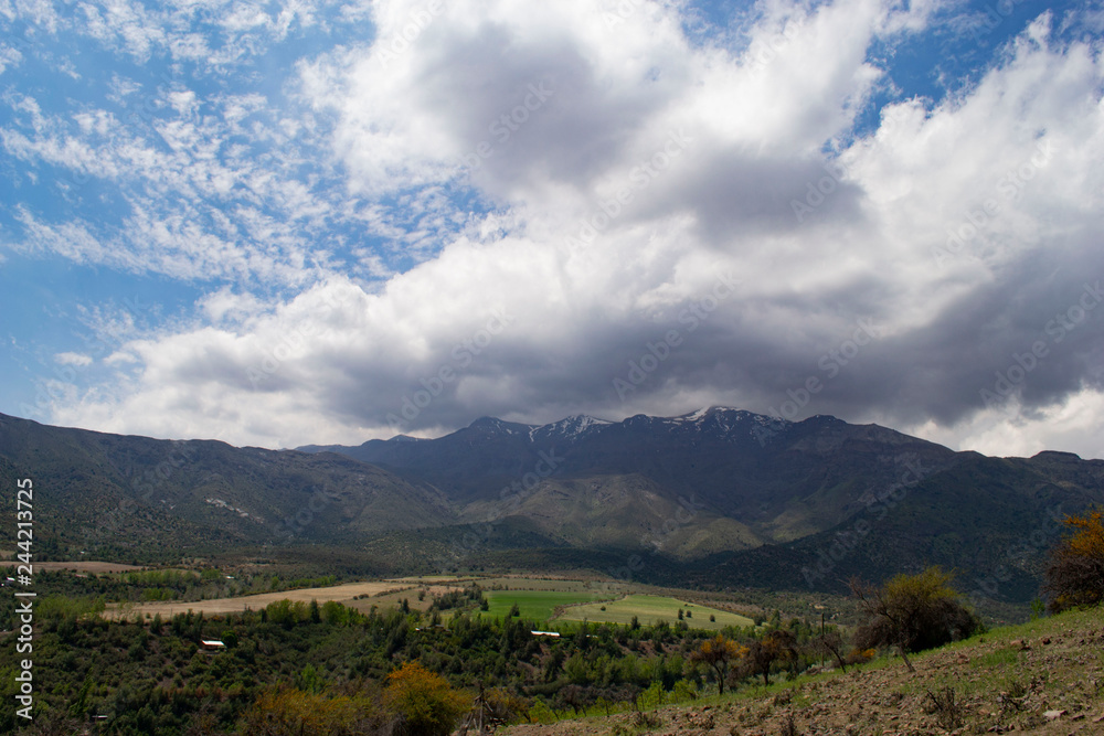 Fototapeta premium view of the valley between the mountains. view from above. to a residential valley. around the chilean mountains. below the village and ponds