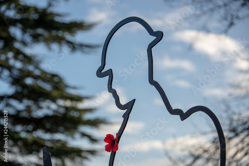 Картината върху платно cut out figure of soldier wearing a poppy with blue sky shining through as a sym