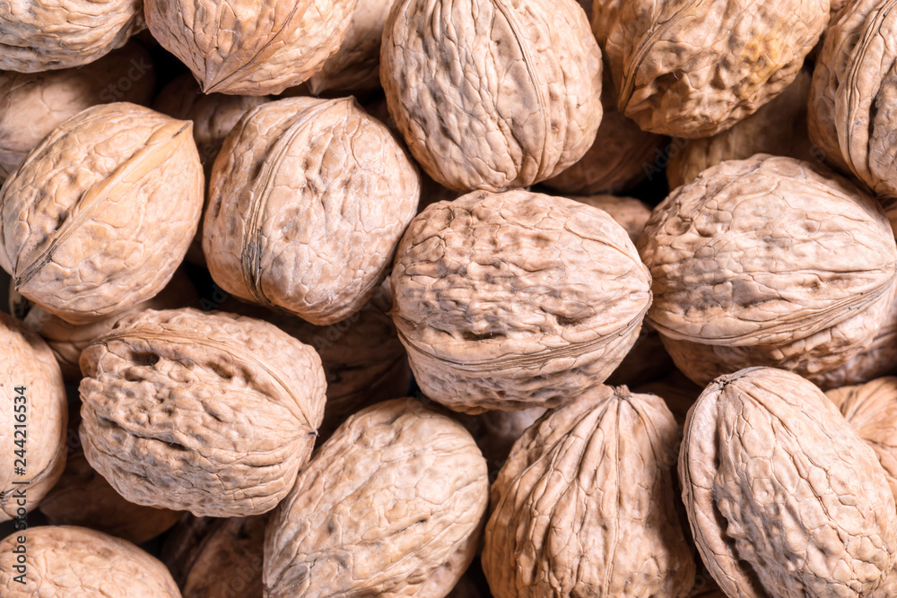 Walnuts in a shell background, close-up, top view Walnuts in a shell background, close-up, top view