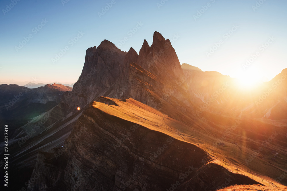 Half of territory is without sunlight. Beautiful sunset in the Italian majestic Seceda dolomite mountains