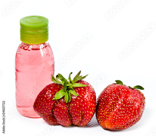 strawberry  ripe berries and cosmetic bottle
