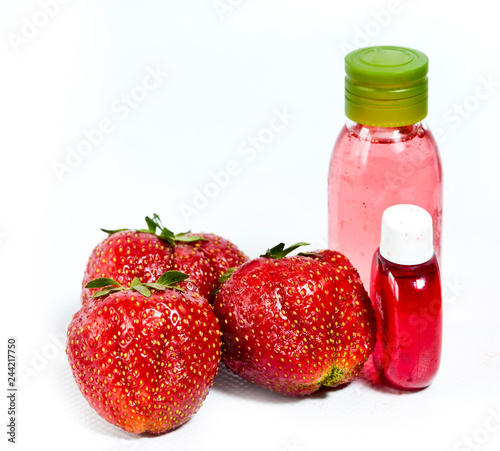 strawberry  ripe berries and cosmetic bottle