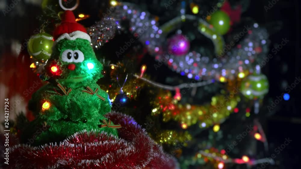 Christmas tree toy sings near a large Christmas tree. New Year and Christmas songs. Family celebration. Present. Making wishes Christmas miracles.