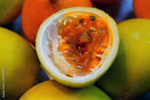 Basket of colorful ripe passion fruits at a food market photo