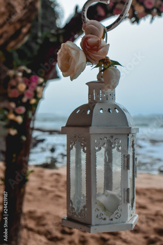 White lantern on a beach wedding decoration with wedding arch in Bali Indonesia