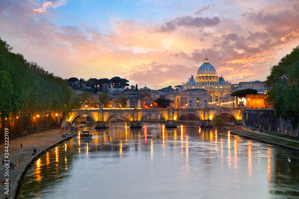 St. Peter's Basilica and Bridge Sant Angelo at sunset in Rome, Italy