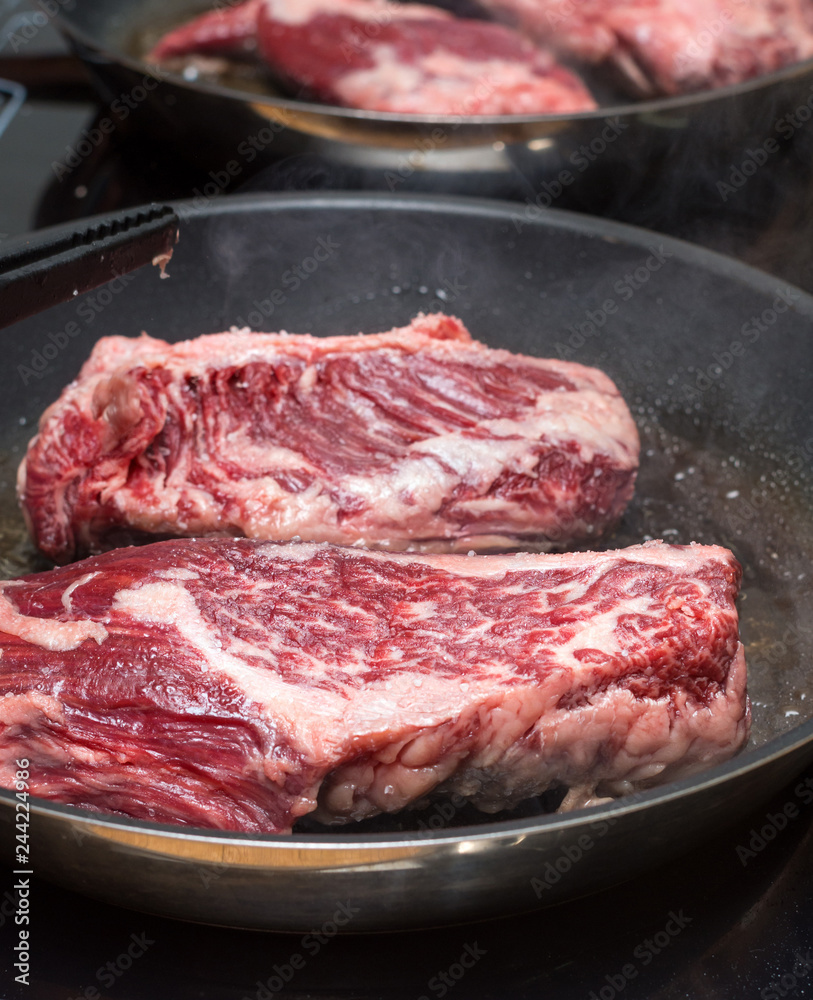 Raw steak on the pan