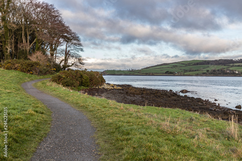 Sunset in Strangford lough with walking trail and farms in background