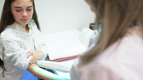 hands of a patient with psoriasis close-up under an ultraviolet lamp. Light therapy, phototherapy