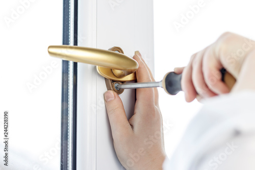 gold pen. Fasten the window handle screw to the PVC window. photo