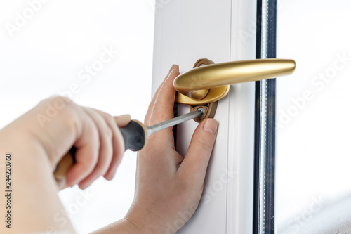 gold pen. Fasten the window handle screw to the PVC window. photo