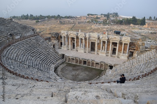Theater antique. The woman in white in the ancient theatre. The ancient stairs. Antique staircase in the ancient theater. Pamukkale. Denizli. Turkey	