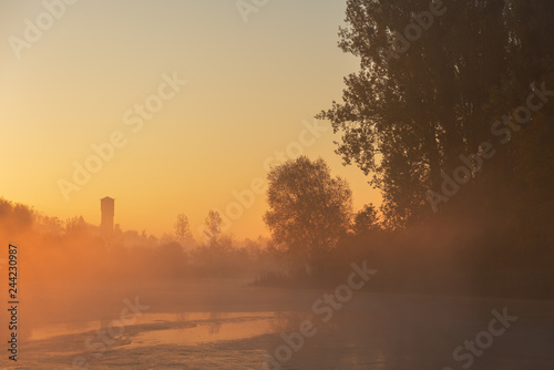 Fototapeta Naklejka Na Ścianę i Meble -  Golden misty morning in the autumn lake with a soft, lovely light