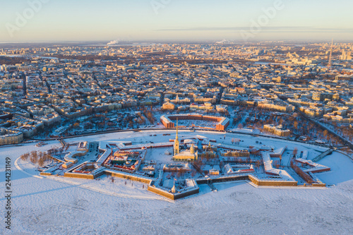 Beautiful aerial winter sunny view of Saint-Petersburg, Russia, Peter and Paul Fortress with cityscape and scenery beyond the city, shot from drone