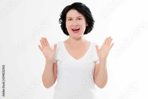 Surprised shocked excited asian middle age woman wrinkle face isolated on white background. Female in blank template summer t shirt. Copy space