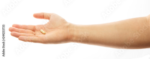 Male hand holding a pill against white background. Medicine. Close-up man hand holding medication, medical capsule. Health care, cure concept. Alpha