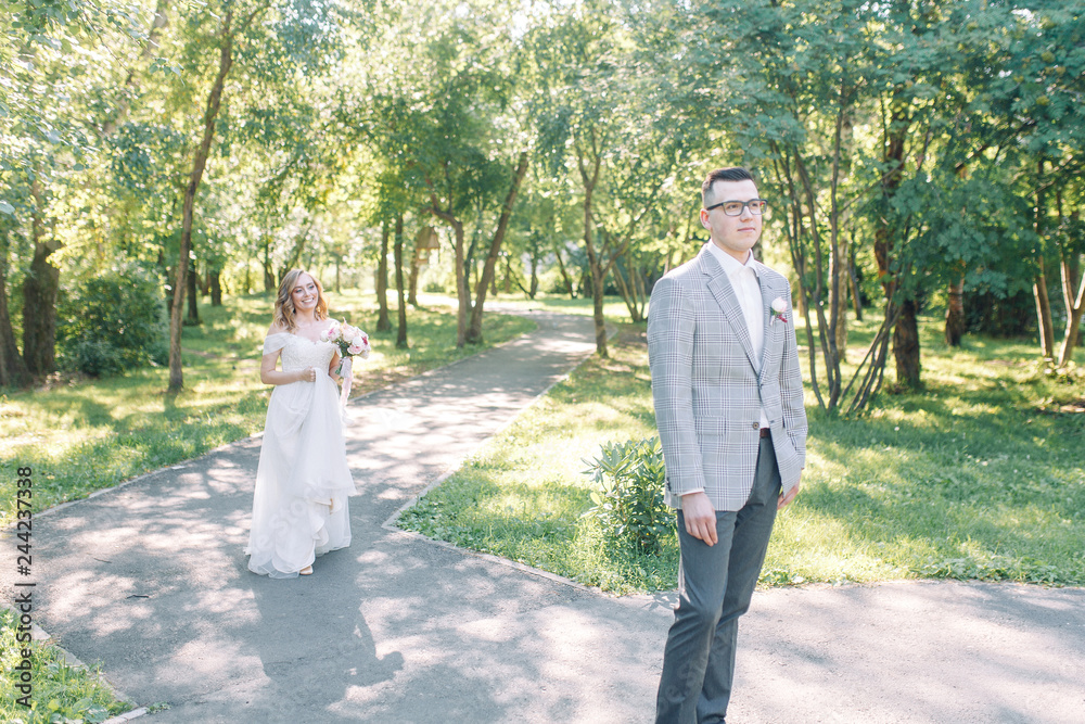Fototapeta premium The wedding couple is walking along the Park. Photo shoot in the European style in nature.
