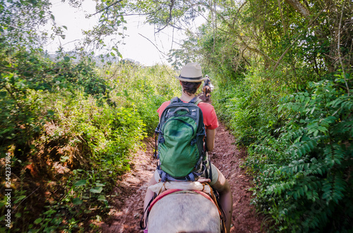 Photography Young woman is riding a horse in the countryside outside Vinjales, Cuba
